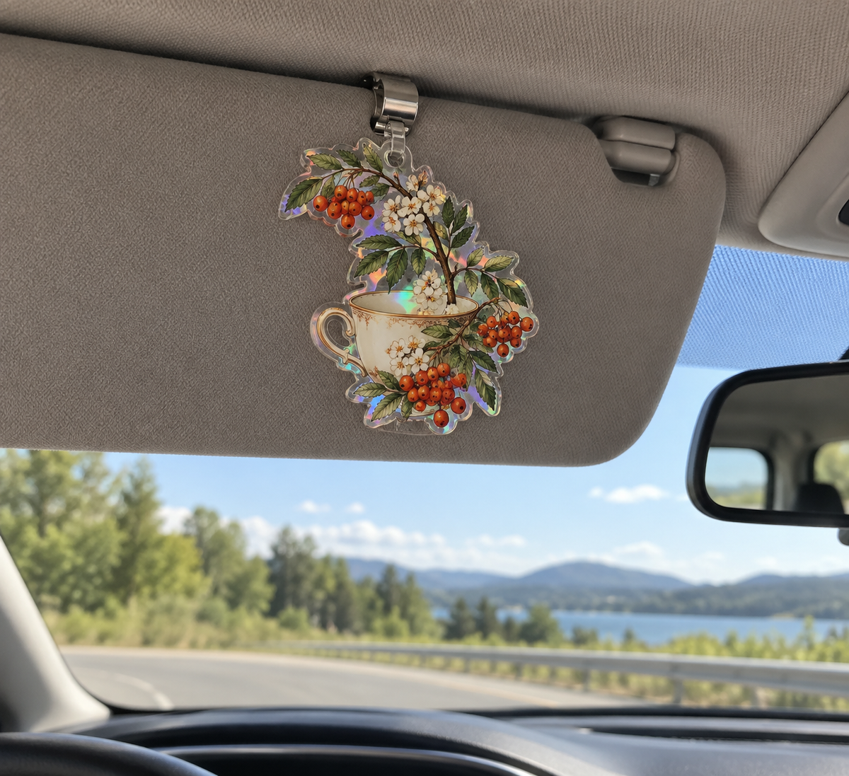 Rowan Teacup Grove Holographic Car Visor Clip with printed optical 3D artwork in its use setting