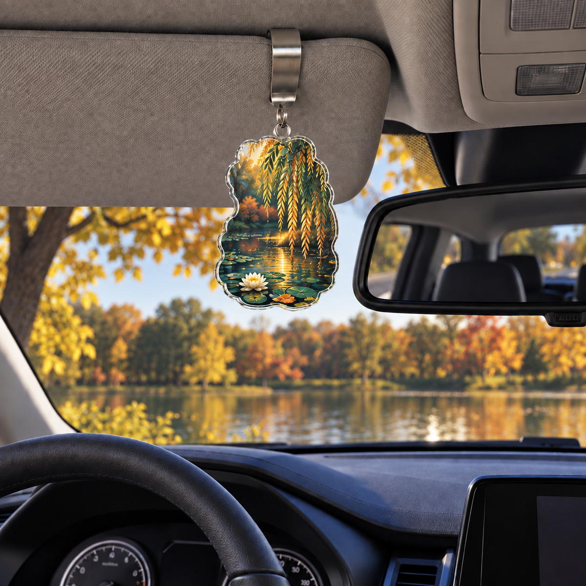 Autumn Willow Pond Holographic Car Visor Clip with printed optical 3D artwork in its use setting