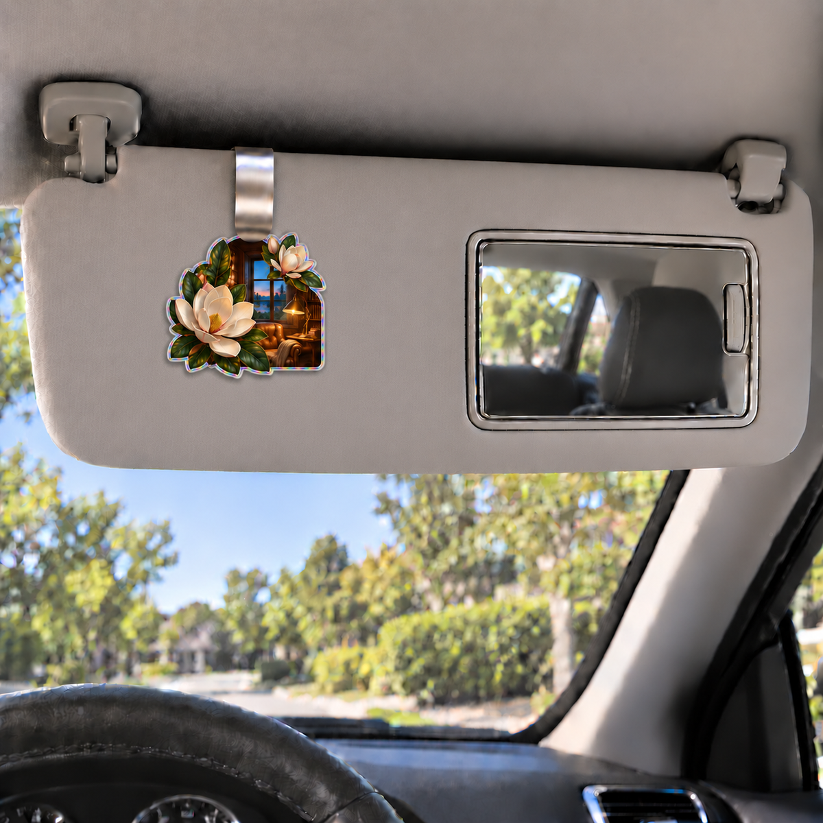 Magnolia Reading Alcove Holographic Car Visor Clip with printed optical 3D artwork in its use setting