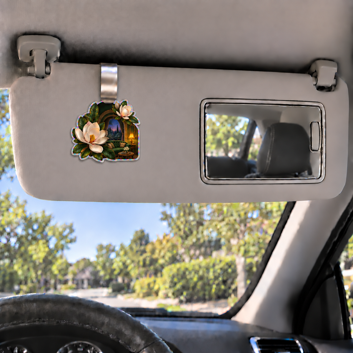 Magnolia Grand Salon Holographic Car Visor Clip with printed optical 3D artwork in its use setting