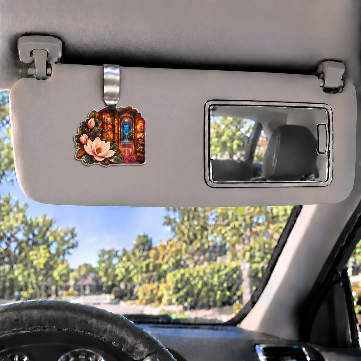 Magnolia Birthday Keepsake Holographic Car Visor Clip with printed optical 3D artwork in its use setting