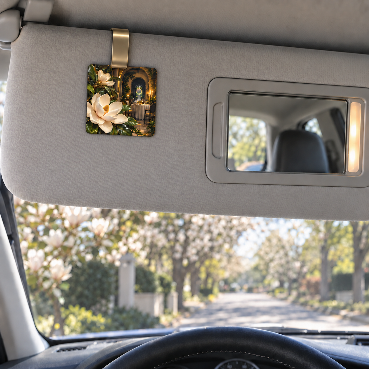 Magnolia Host Gift Holographic Car Visor Clip with printed optical 3D artwork in its use setting